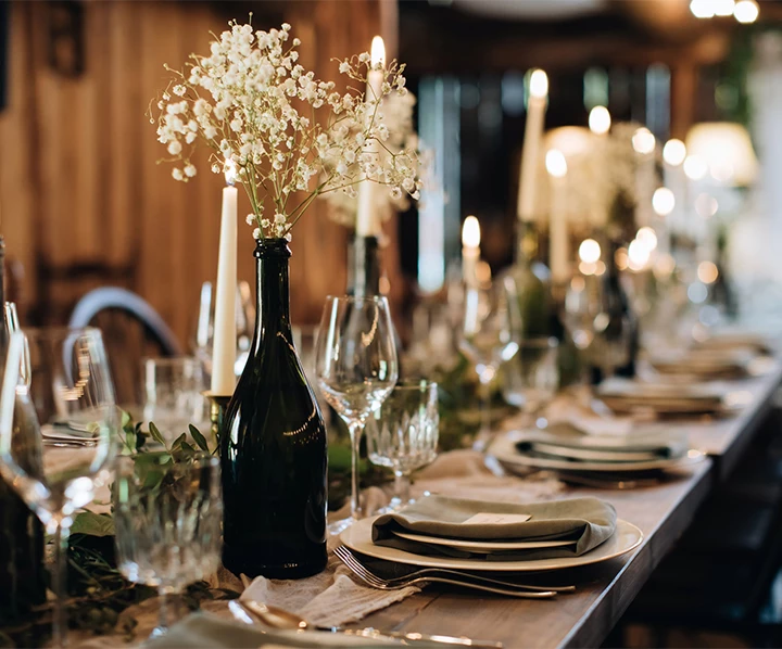 a table set with wine glasses and wine bottles