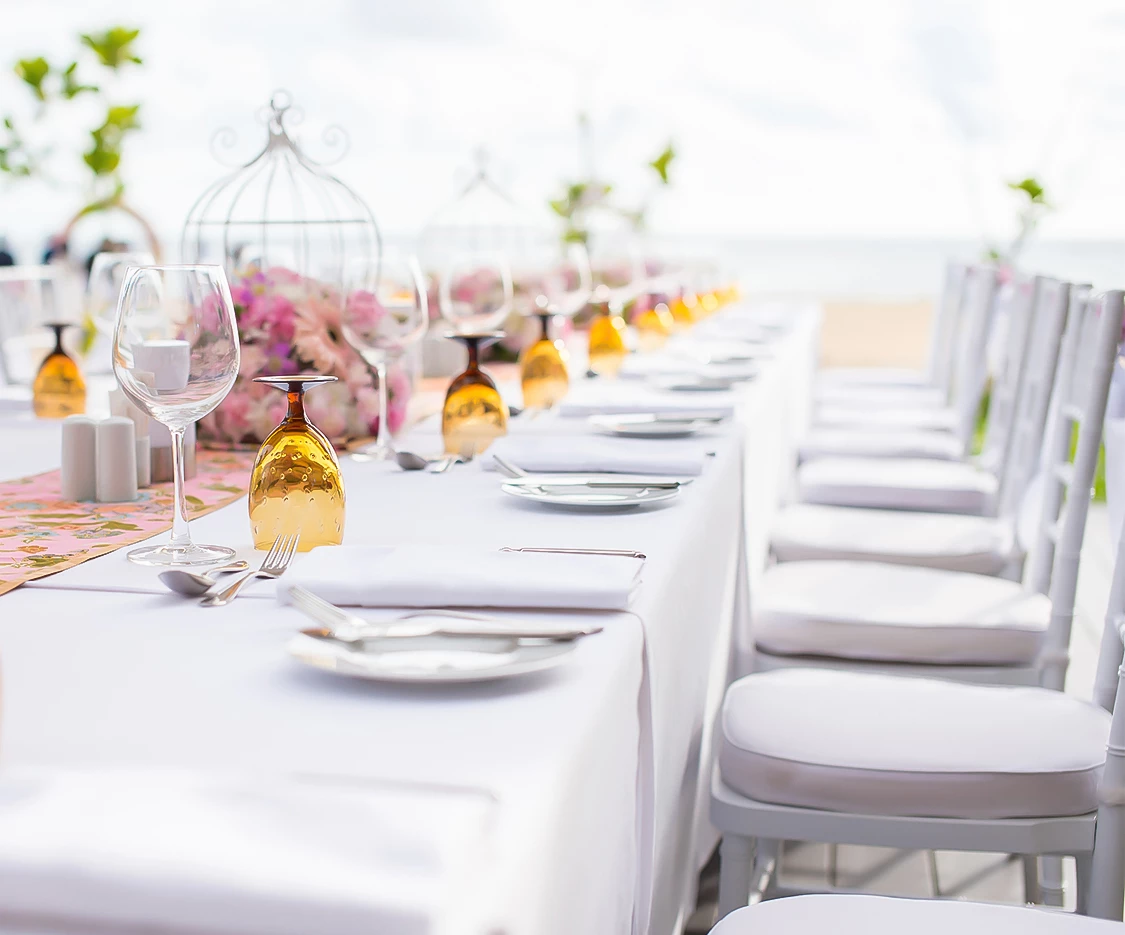 a long table with white tablecloths and wine glasses