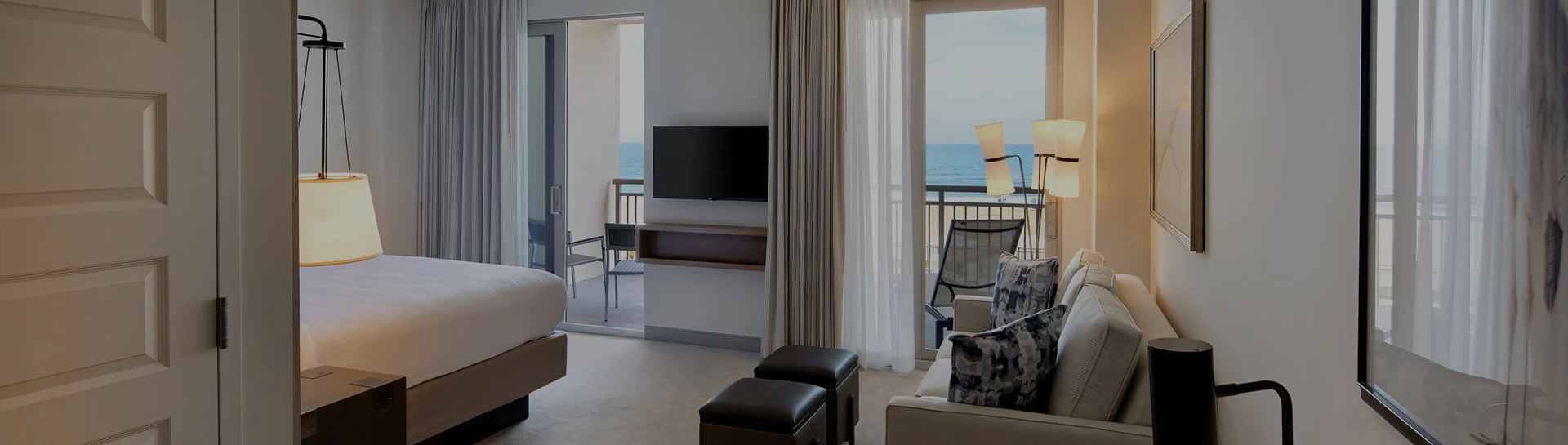 a living room with a television and a balcony