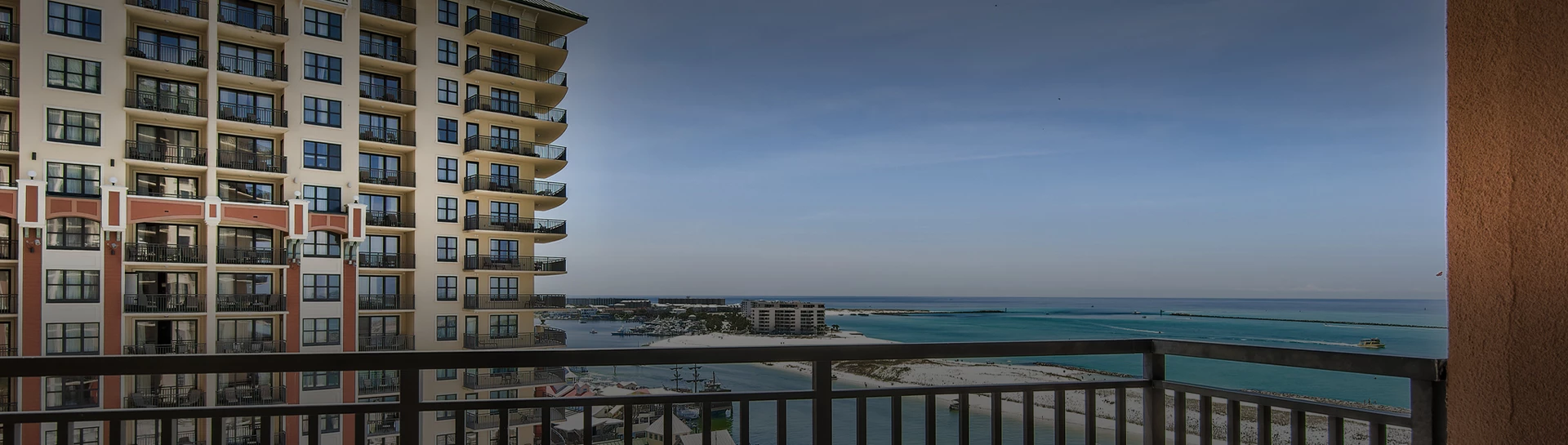 a balcony with a beach and buildings
