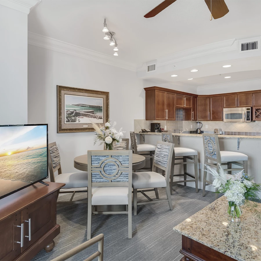 a room with a television and dining area