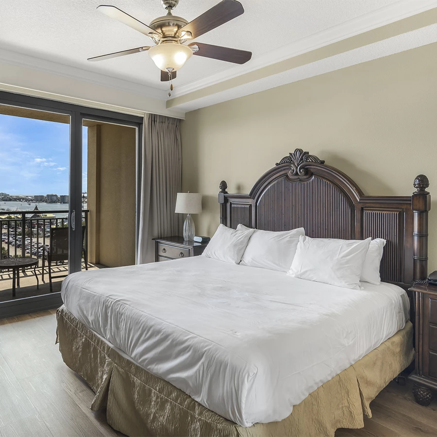 a bedroom with a large bed and a ceiling fan