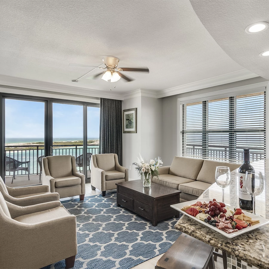 a living room with a table and chairs and a glass door