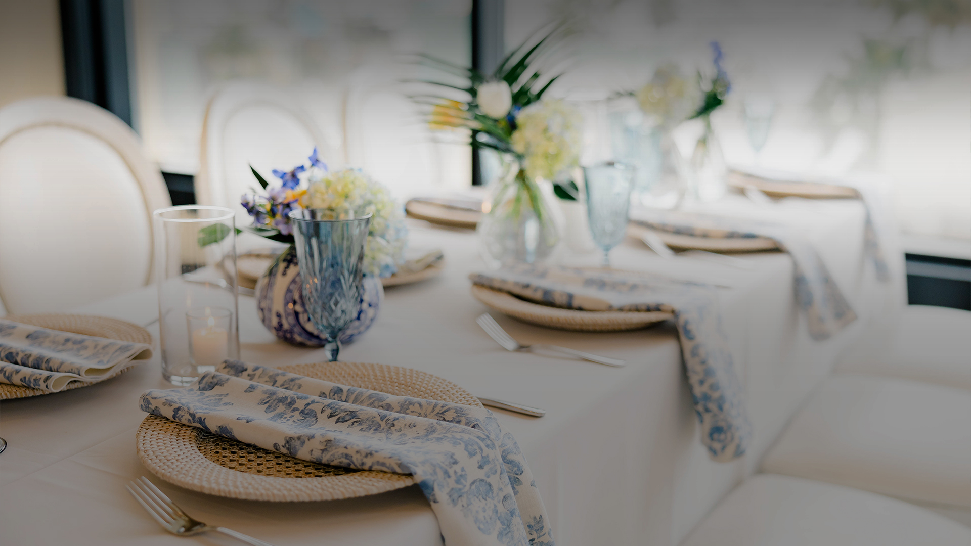 a table with plates and glasses and flowers