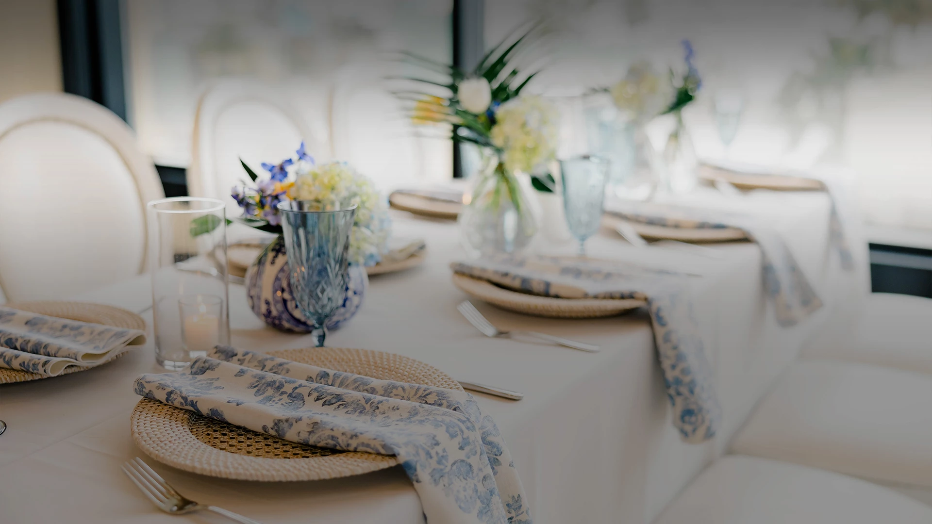 a table with plates and glasses and flowers