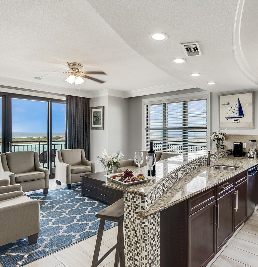 a living room with a kitchen and a bar