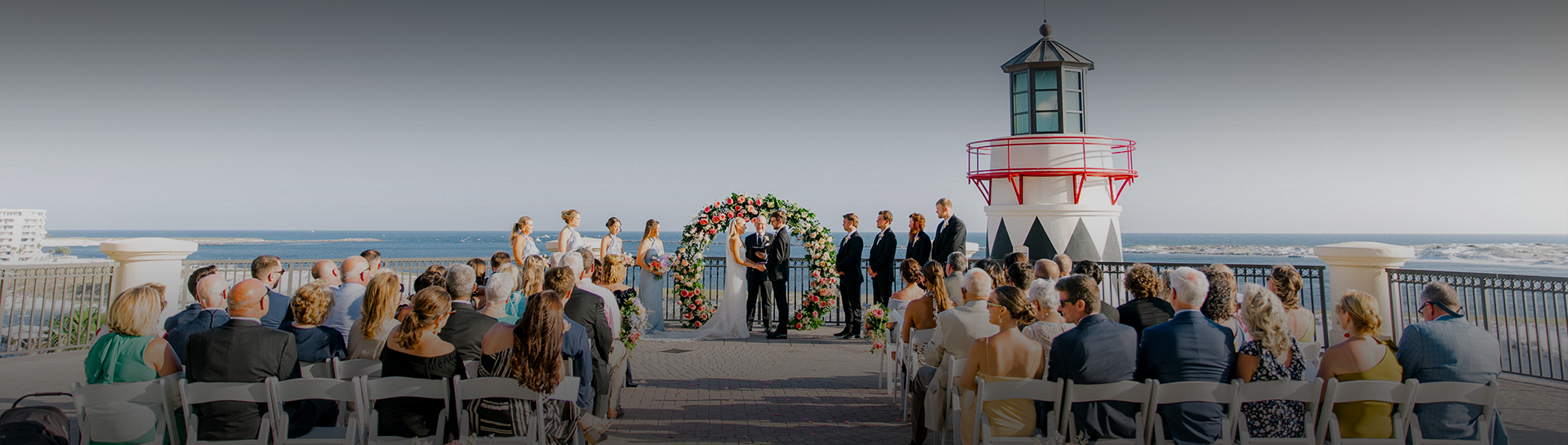 a group of people standing around a wedding ceremony