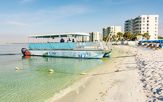 a group of people on a boat on a beach