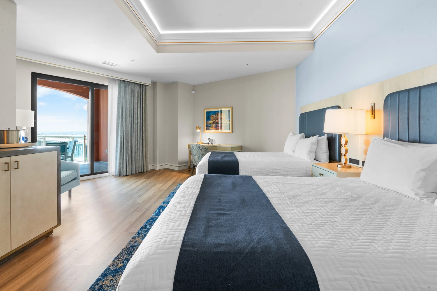 a room with two beds and a table with a lamp