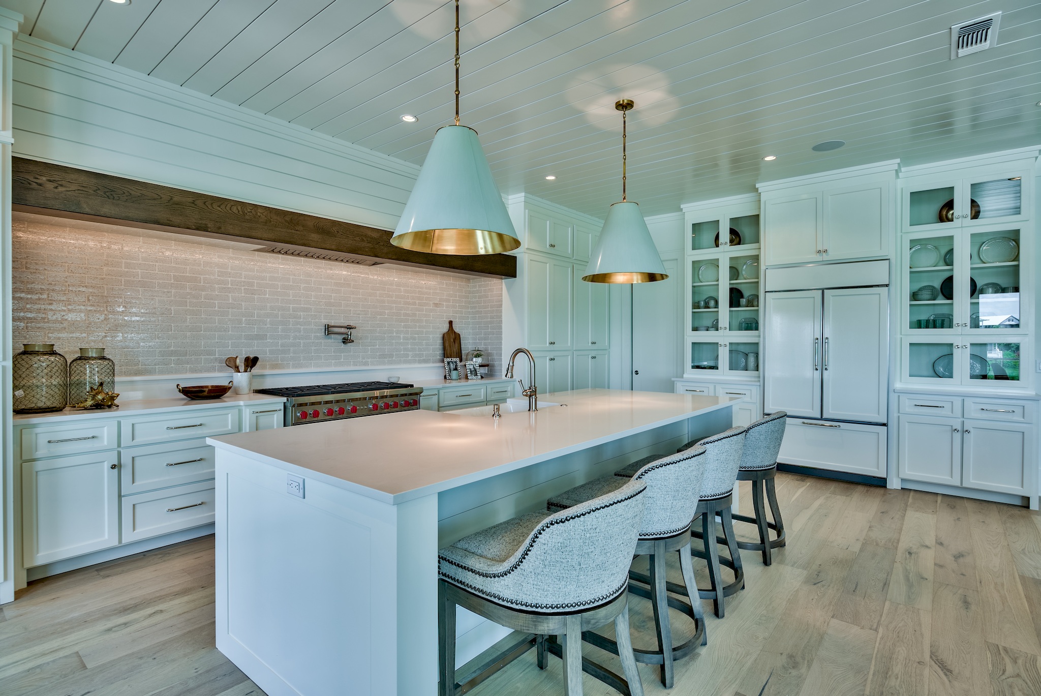 a kitchen with white cabinets and white countertops