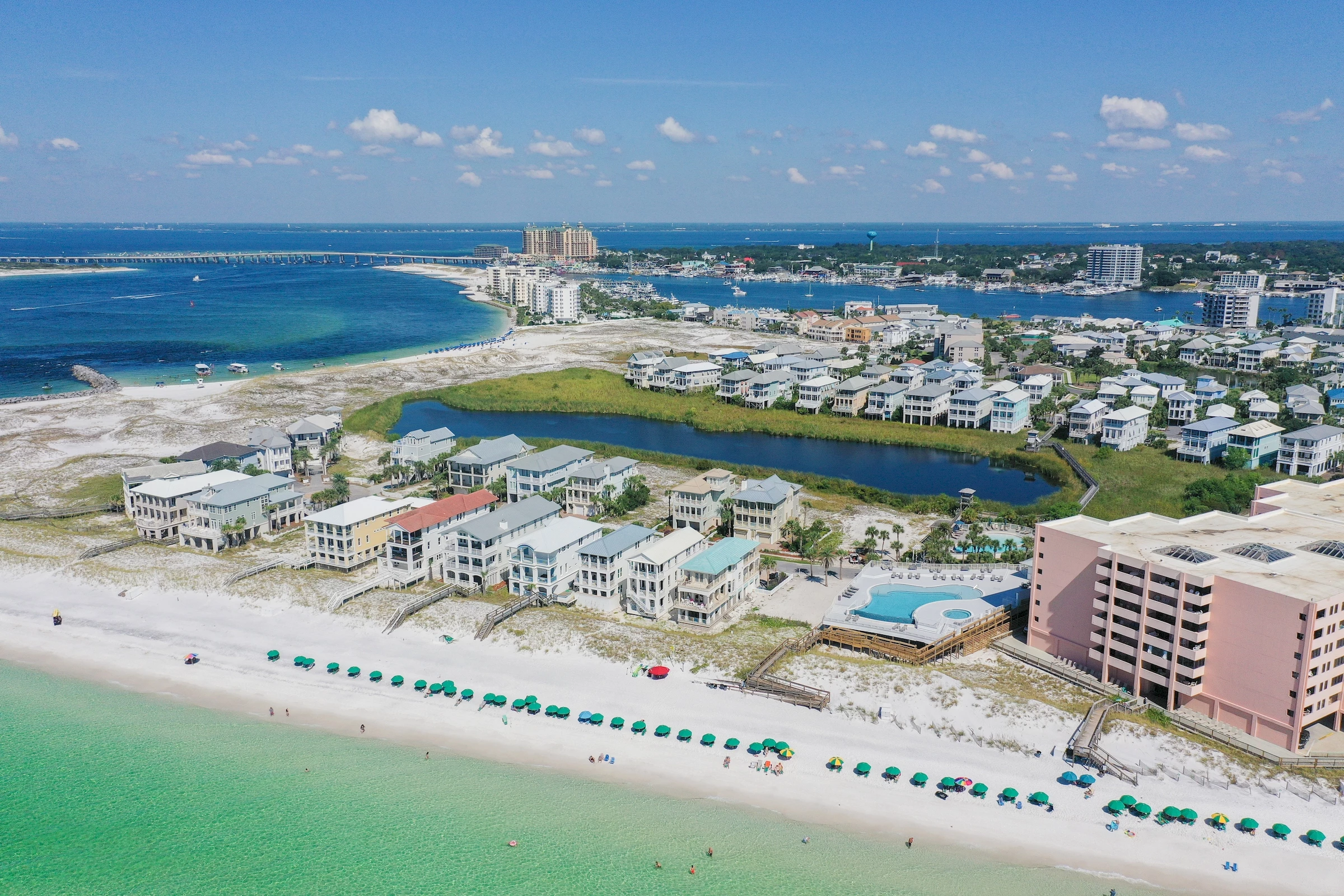 a beach with buildings and a body of water