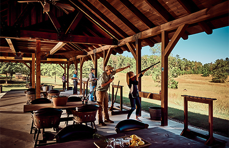 a man pointing a gun at a shooting range