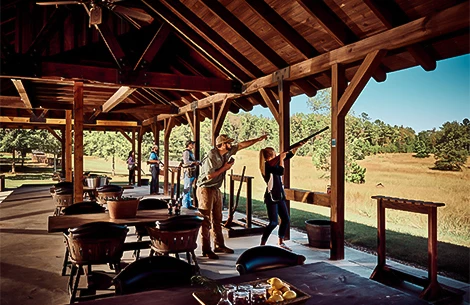 a man pointing a gun at a shooting range
