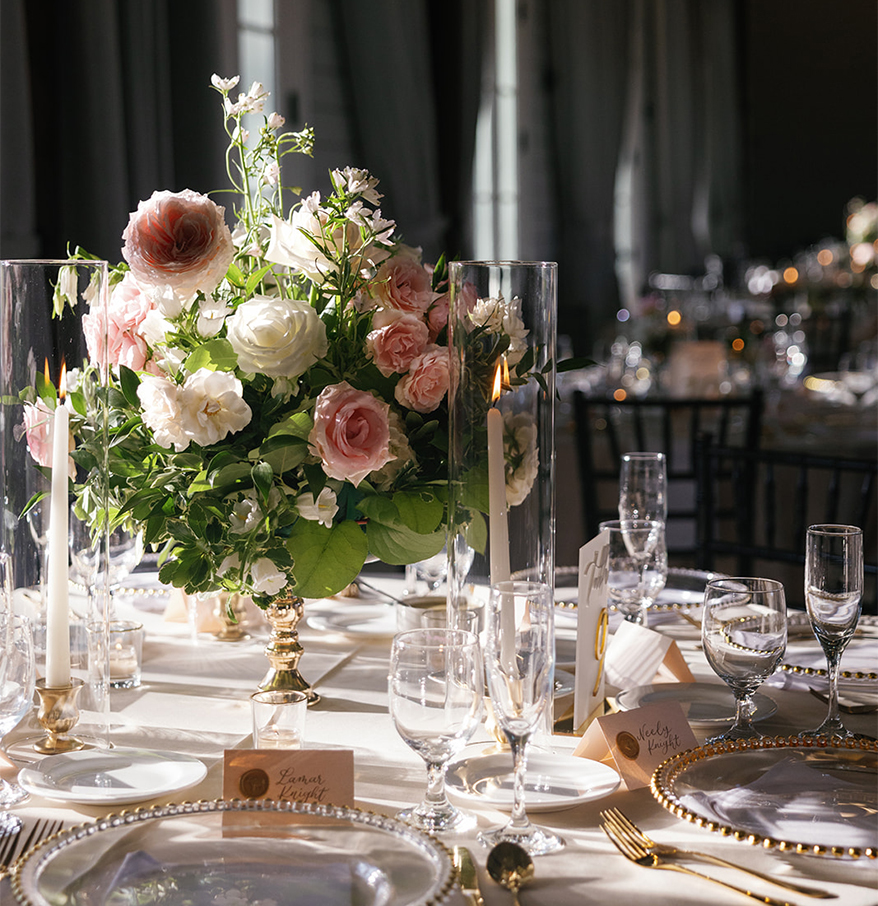 a table set with flowers and candles