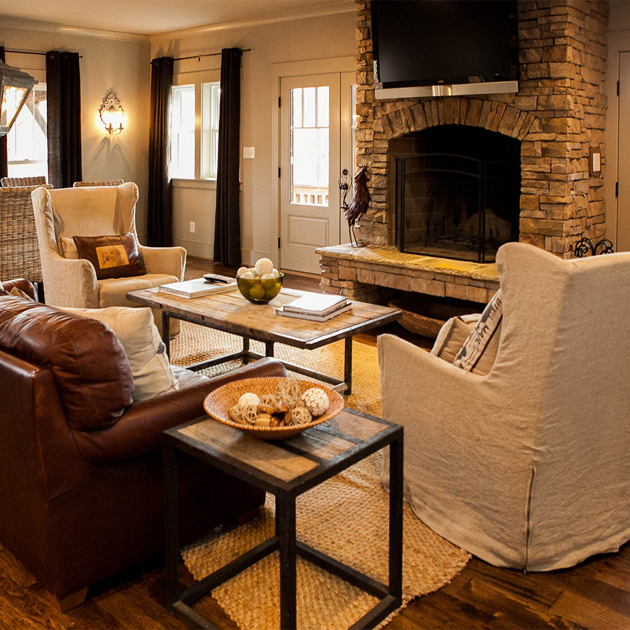 a living room with a fireplace and couches
