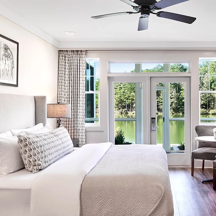 a bedroom with a large bed and a ceiling fan