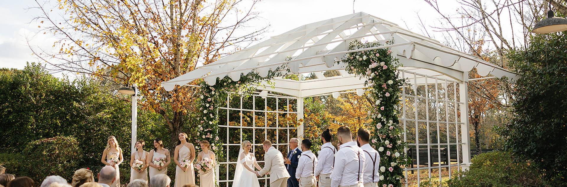 a wedding ceremony under a white structure