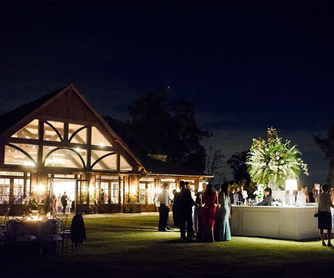 a group of people outside the legacy lookout at night