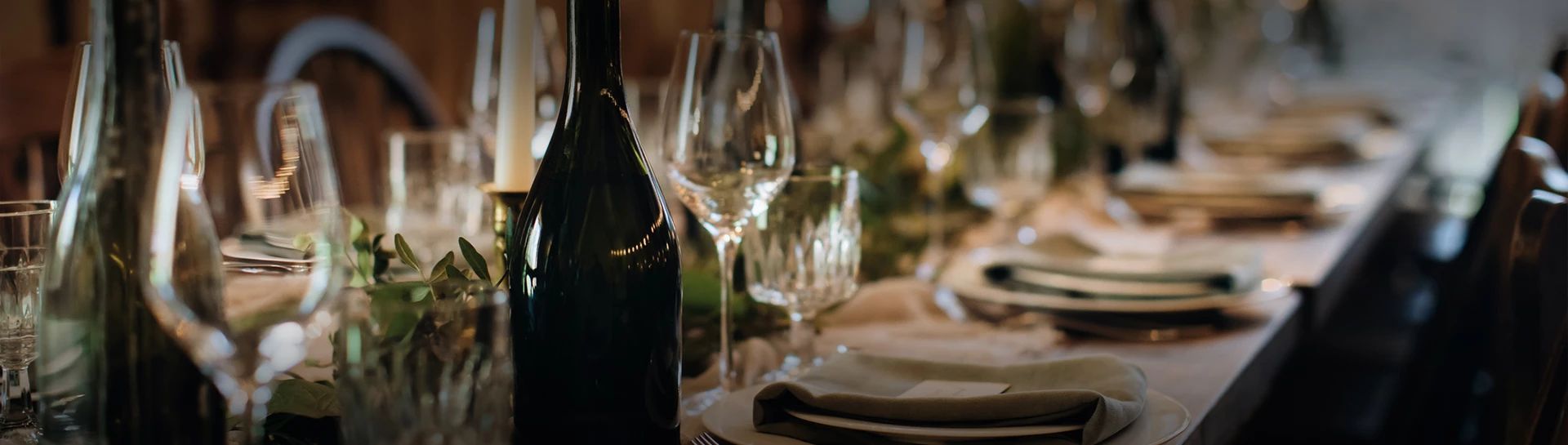 a wine bottle and glasses on a table