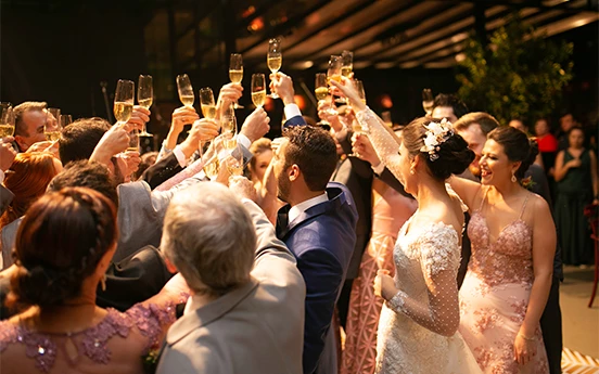 a group of people holding up glasses of champagne
