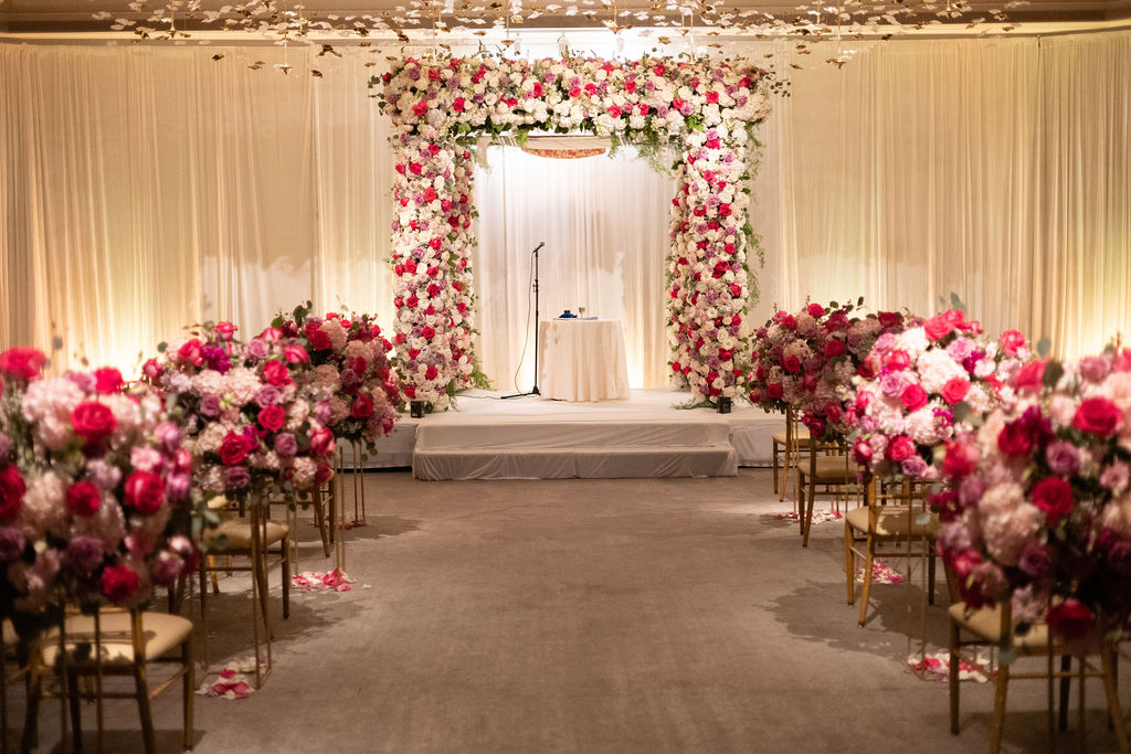a wedding ceremony with chairs and flowers