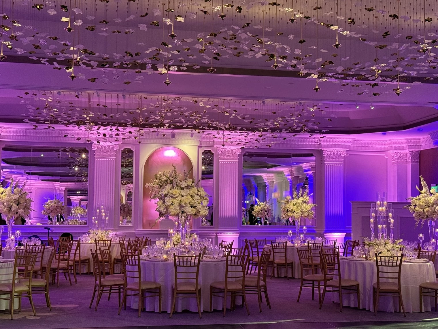 a room with tables and chairs and flowers