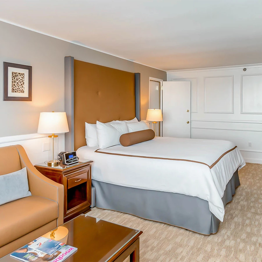 a hotel room with a bed and a chair