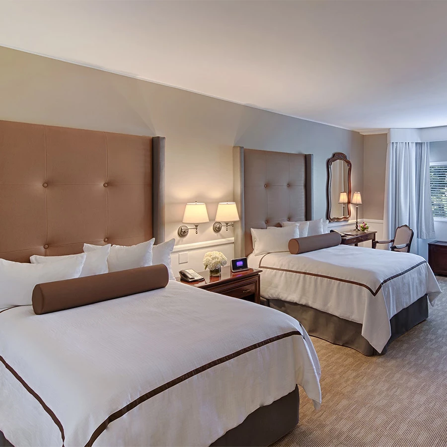 a room with two beds and a mirror