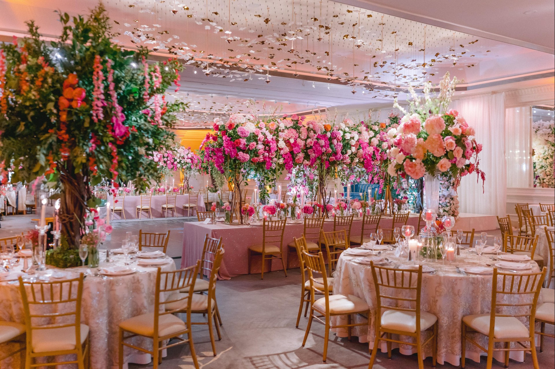 a room with tables and chairs and flowers
