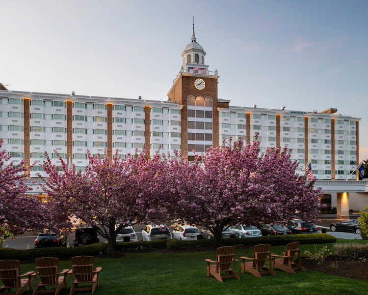 a large building with a clock tower and lawn chairs