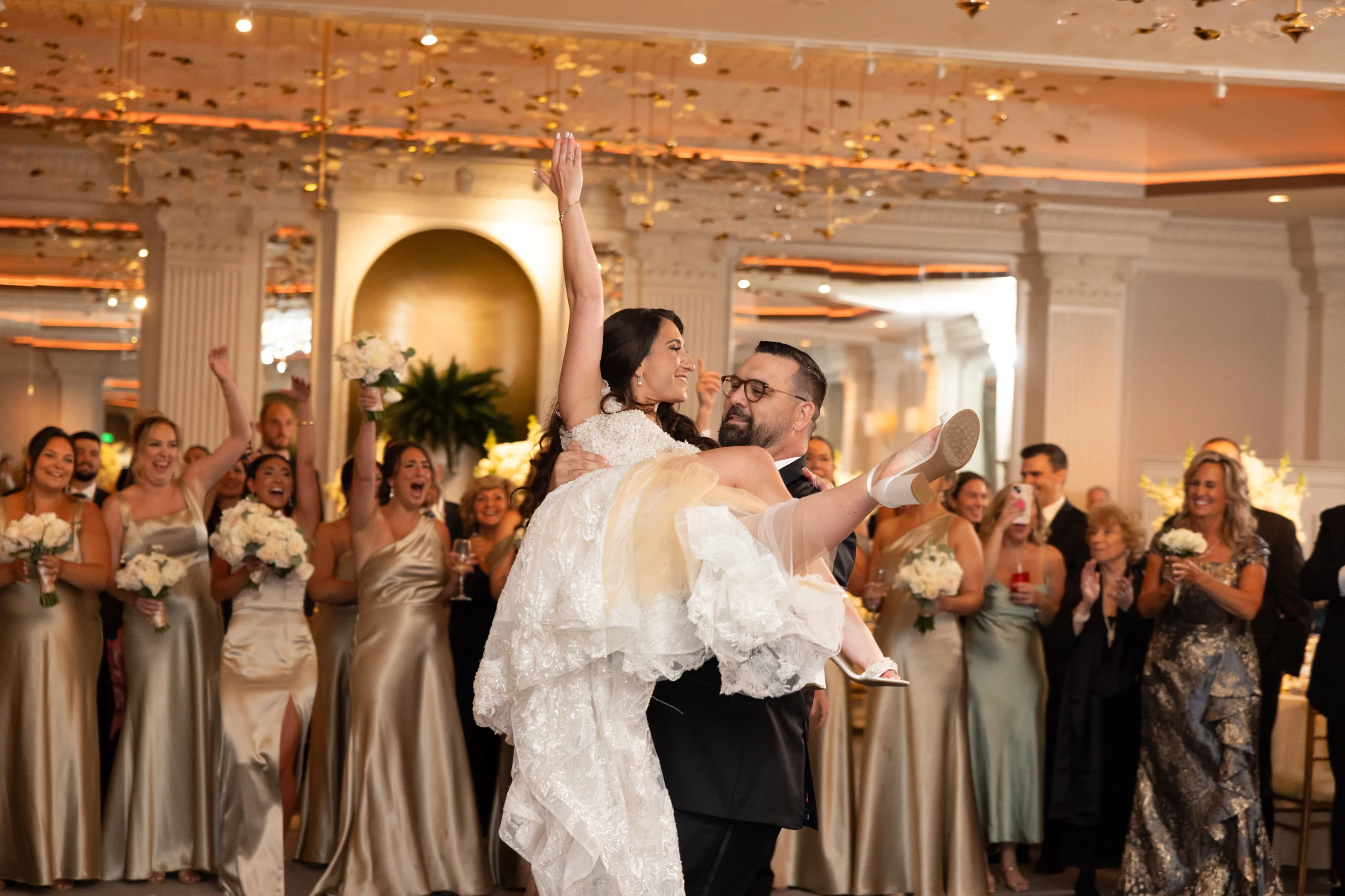 a man carrying a woman in a wedding dress