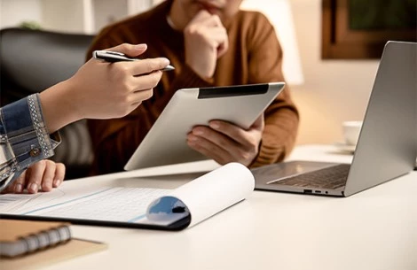 a person holding a tablet and a pen