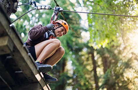 a woman wearing a helmet and climbing equipment