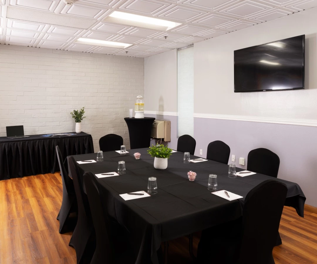 a room with black chairs and tables