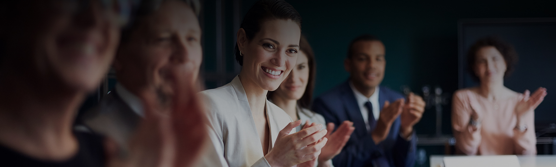 a woman smiling and clapping her hands
