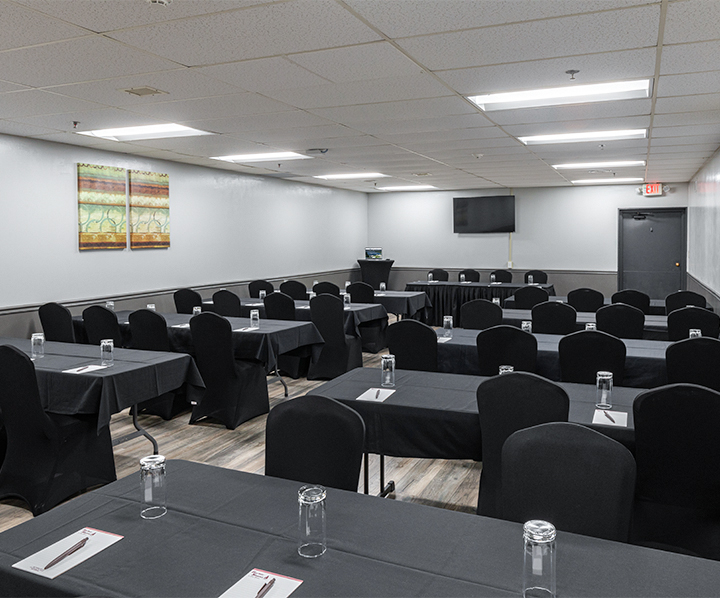 a room with black tables and chairs