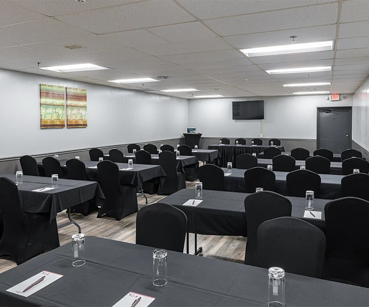 a room with black tables and chairs
