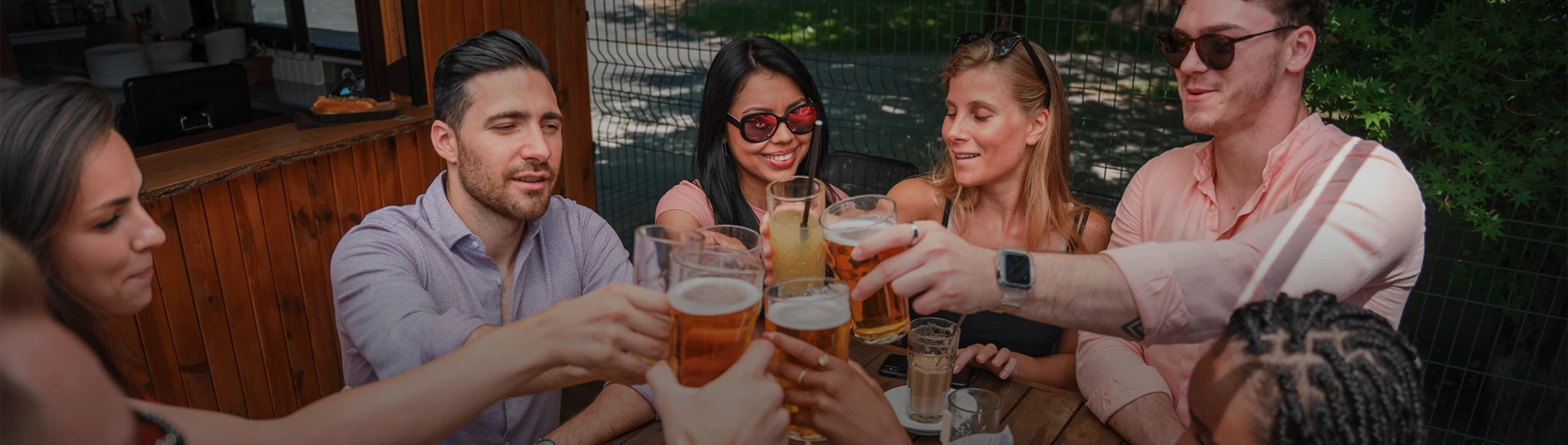 a group of people clinking glasses of beer
