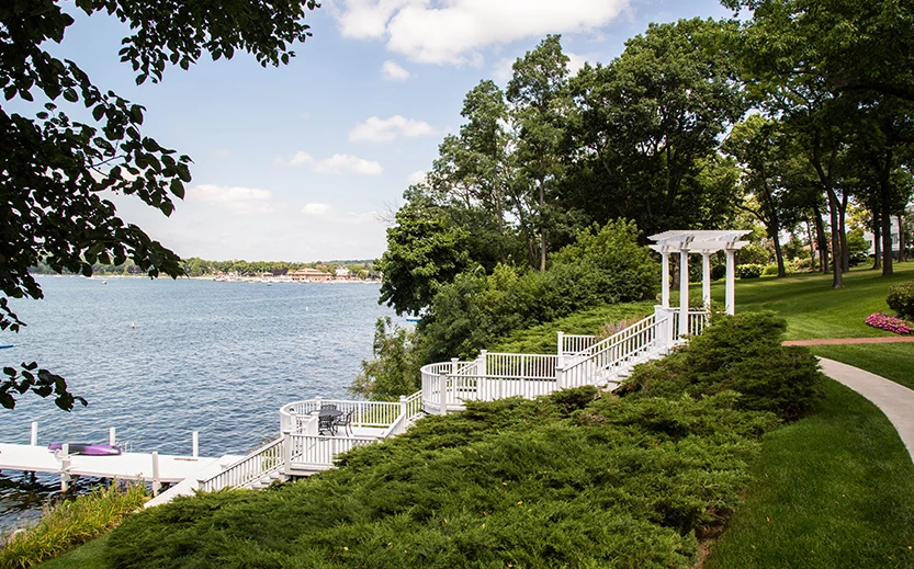 a white stairs leading to a body of water