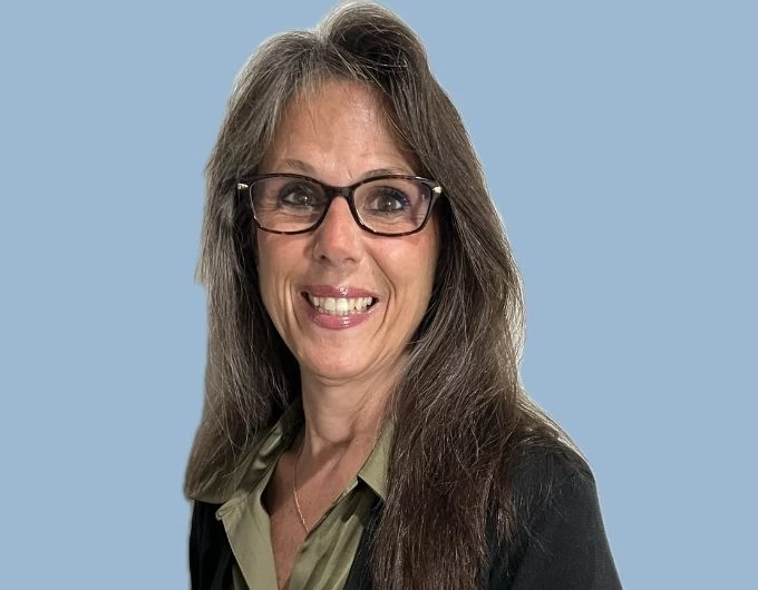 a woman with long hair wearing glasses
