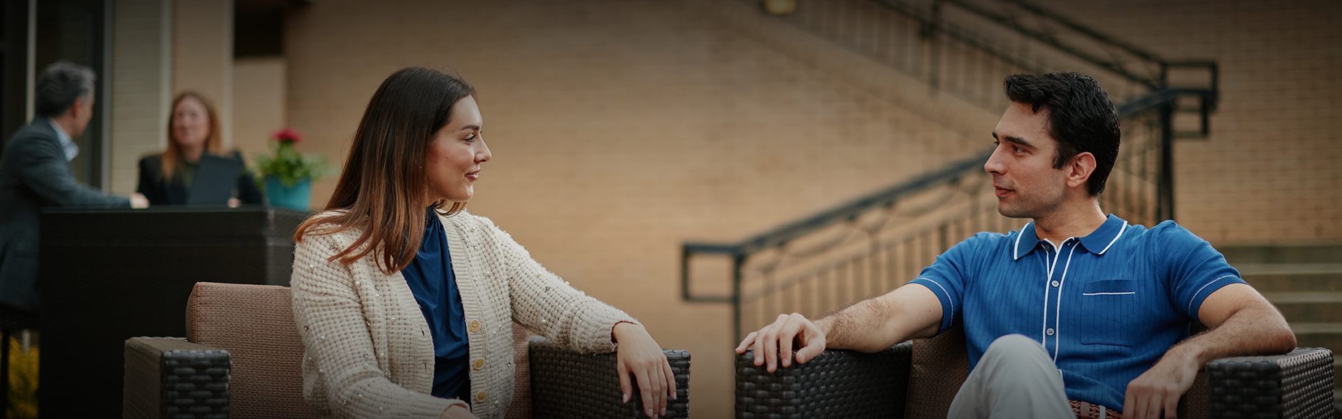 a man and woman sitting on chairs