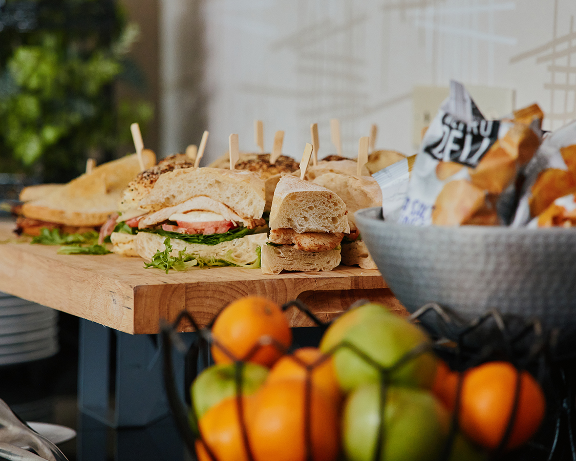 a table with sandwiches and fruit