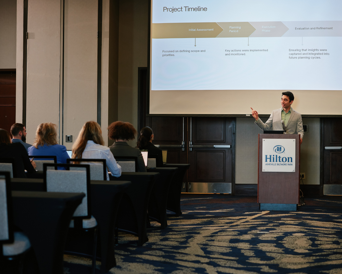 a man standing at a podium giving a presentation