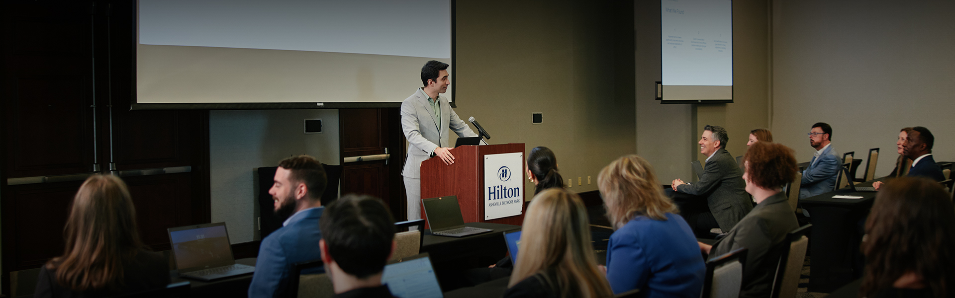 a man standing at a podium with a microphone