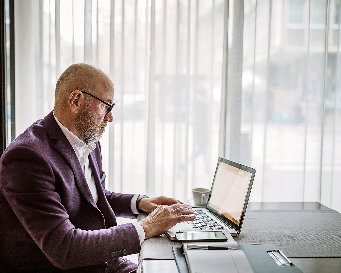 a man in a suit using a laptop