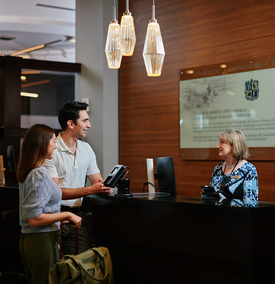 a man and woman standing at a desk
