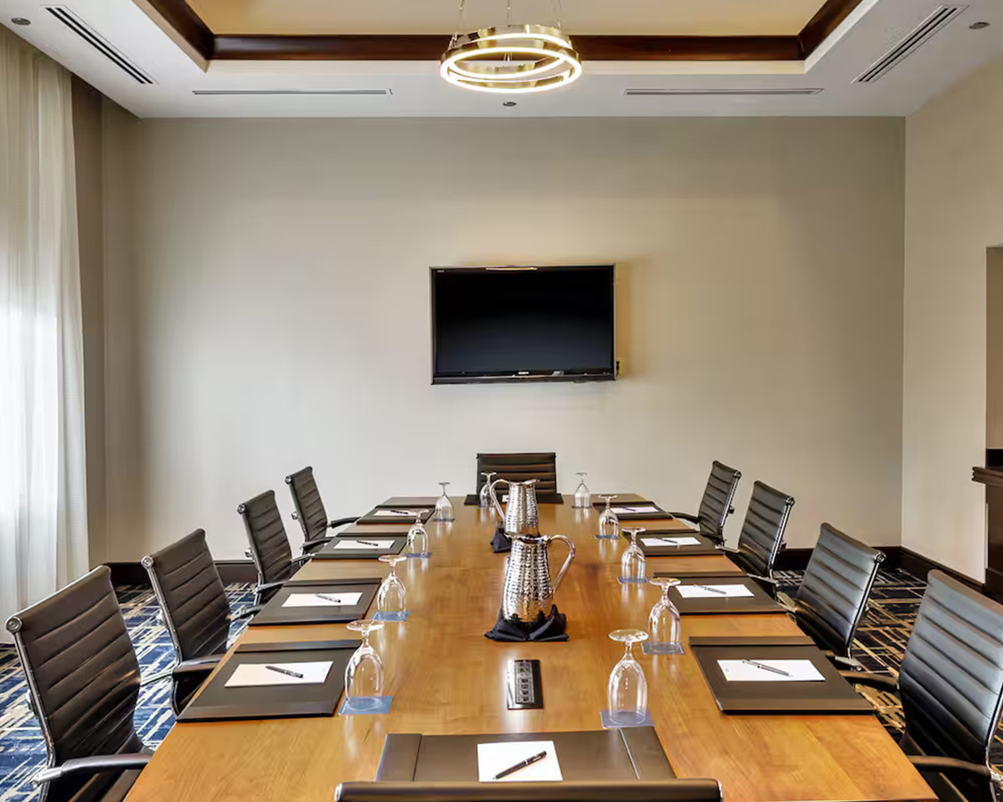 a conference room with a table and chairs