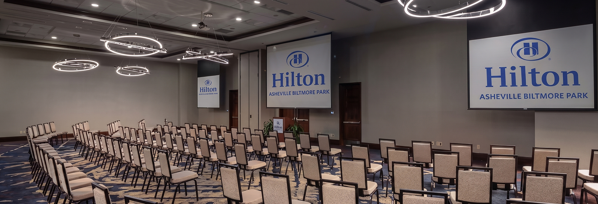 a room with chairs and a projector screen
