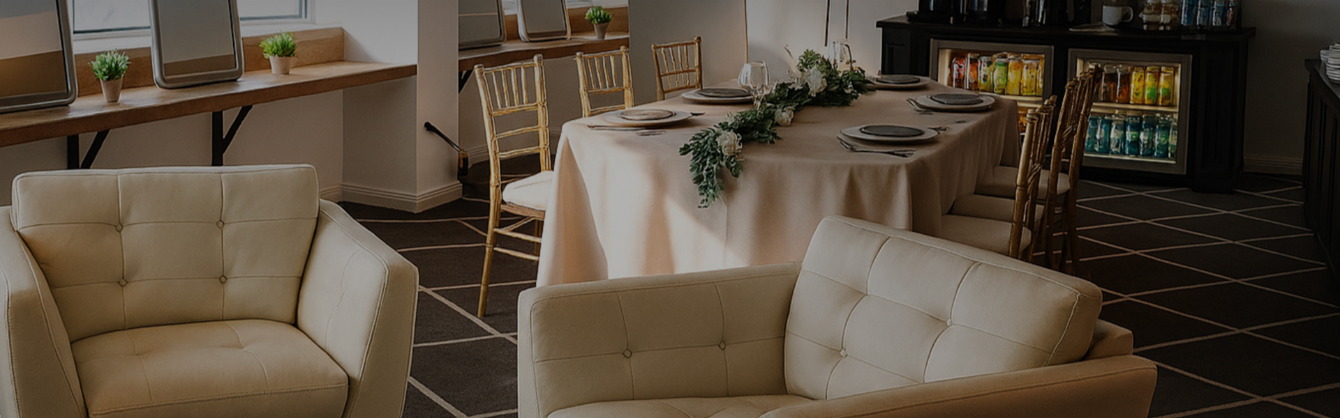 a table with a long table with a white couch and chairs