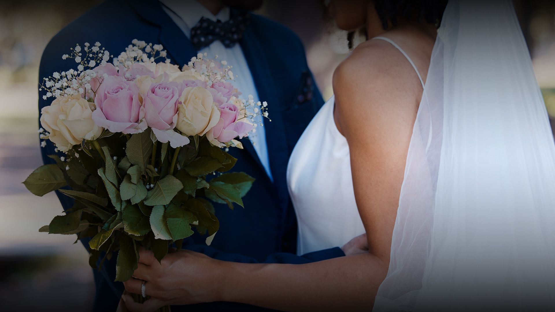 a man and woman holding flowers